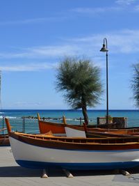 Boat moored on sea against sky