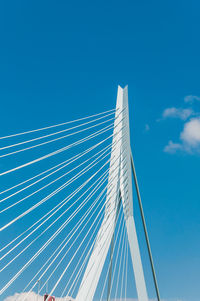 Low angle view of suspension bridge against sky