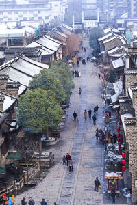 High angle view of people walking in city