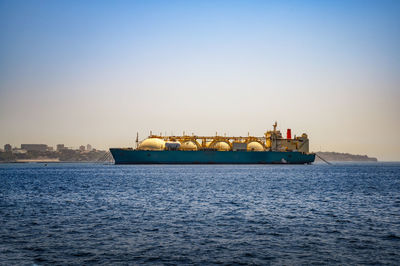 Boat in sea against clear sky