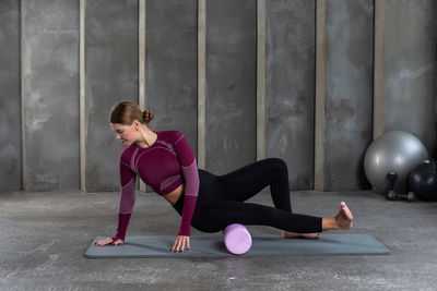 Young woman exercising in gym