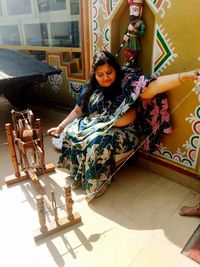 Portrait of woman sitting on floor at home