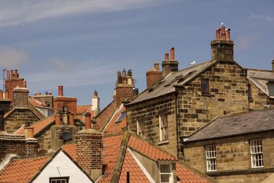 Buildings in city against sky