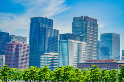 Modern buildings in city against sky