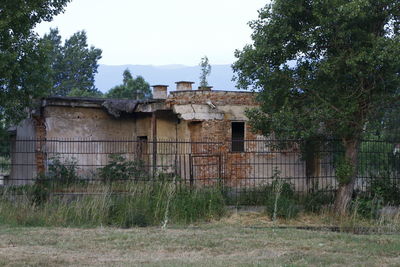 Abandoned building with trees in background