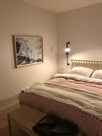 Electric lamp on bed against wall at home