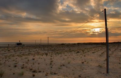 Scenic view of beach against sky during sunset