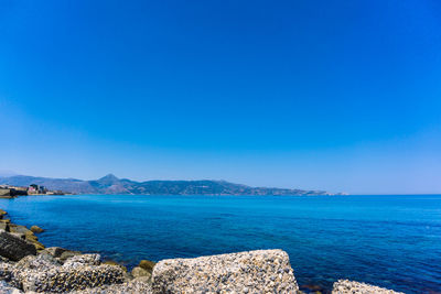 Scenic view of sea against clear blue sky