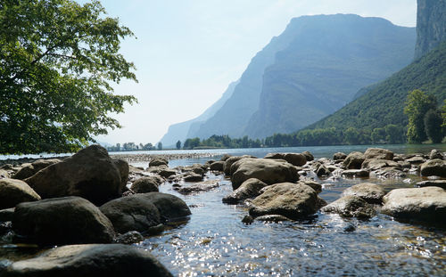 Scenic view of sea and mountains against sky