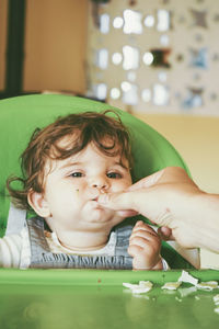 Portrait of cute baby girl on table