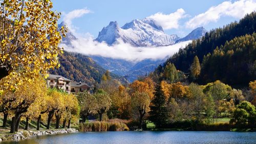 Scenic view of lake by trees against sky during autumn