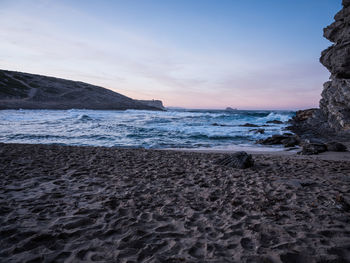 Scenic view of beach against sky during sunset