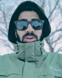 Close-up portrait of young man with snow