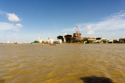 View of building by sea against sky