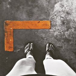 Low section of woman standing on tiled floor
