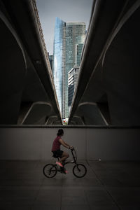 Man riding bicycle on bridge