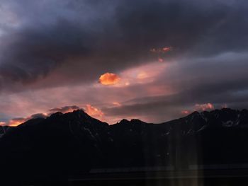 Scenic view of silhouette mountains against sky during sunset