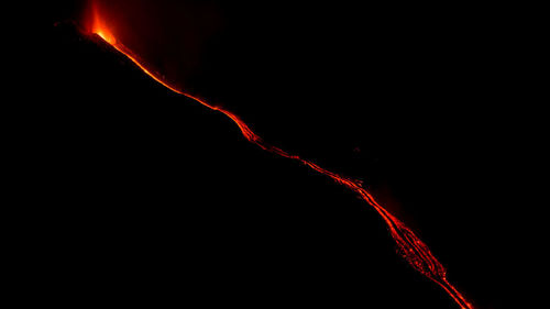 Close-up of red fire against black background
