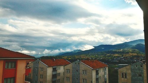 Buildings in town against sky