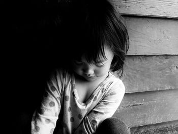 Full length of cute girl sitting outdoors