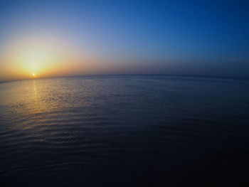 Scenic view of sea against clear sky during sunset