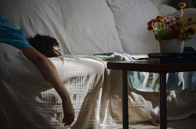 Woman relaxing on sofa at home