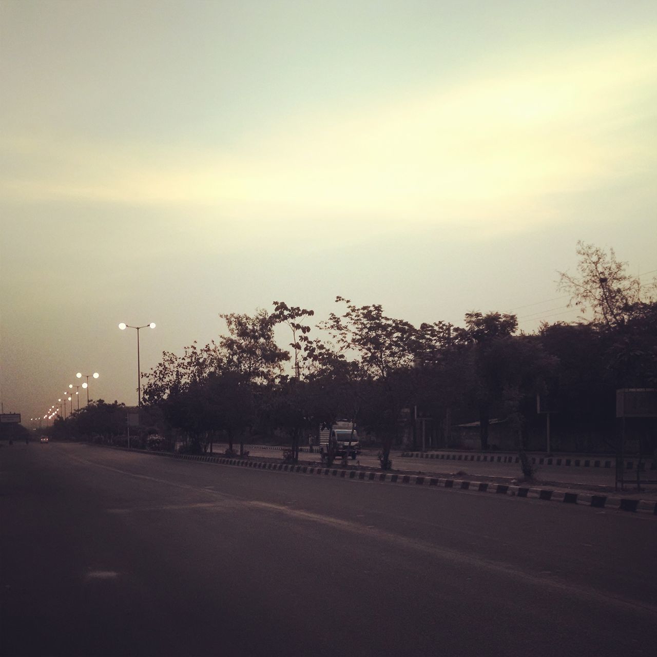 road, the way forward, tree, sky, transportation, street light, street, diminishing perspective, road marking, empty, empty road, landscape, tranquility, country road, tranquil scene, vanishing point, nature, field, outdoors, dusk