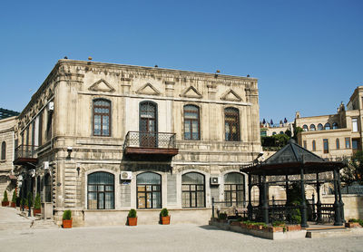 Facade of historic building against clear blue sky