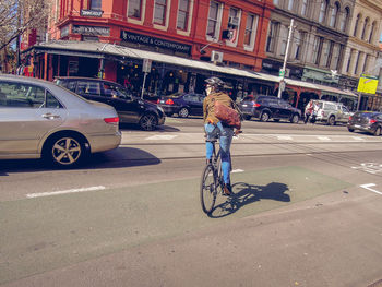 Man riding bicycle on street in city