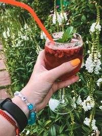 Midsection of woman holding drink