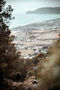 Man standing on rocks against sky