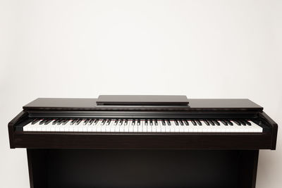 Close-up of piano keys against white background