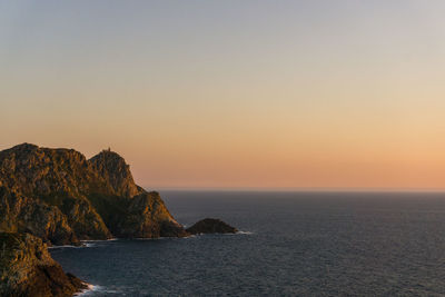 Scenic view of sea against clear sky during sunset