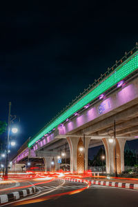 Illuminated bridge against sky at night