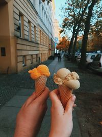 Midsection of woman holding ice cream cone