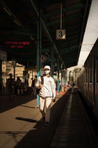 Man standing on railroad station platform