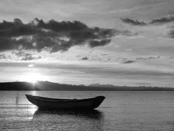 Boat in sea at sunset