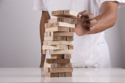 Man playing with stuffed toy on wooden table