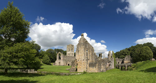 Panoramic view of trees and buildings against sky