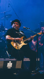 Man playing guitar at music concert