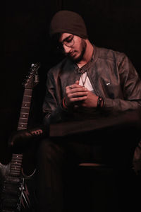 Young man sitting in guitar