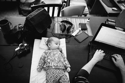 High angle view of people sitting on table at home