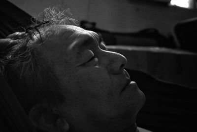 Close-up of mature man sleeping on bed at home