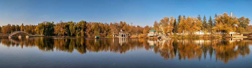 Autumn landscape with a lake and yellow trees in the village of ivanki, cherkasy region, ukraine