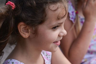 Close-up of cute girl looking away