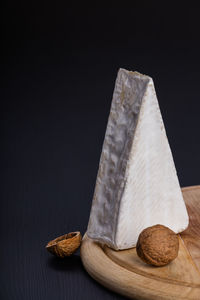 Close-up of cake on table against black background