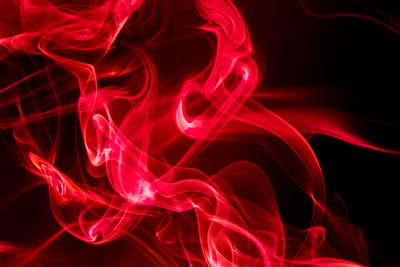 Close-up of red light painting against black background