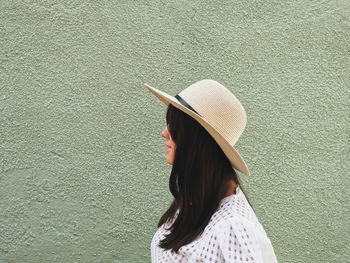 Side view, portrait of a young woman, summer style, hat, pastel, wall, window.