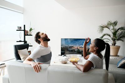 Young couple sitting on table at home