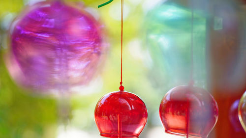 Close-up of christmas decorations hanging on glass